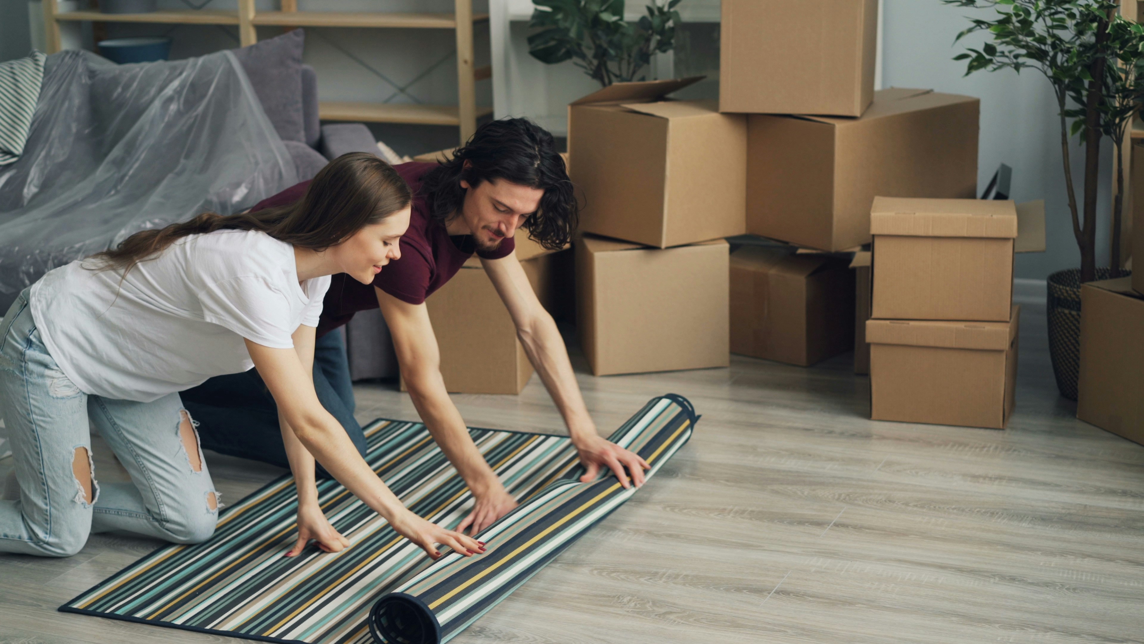 Couple unpacking boxes in new home